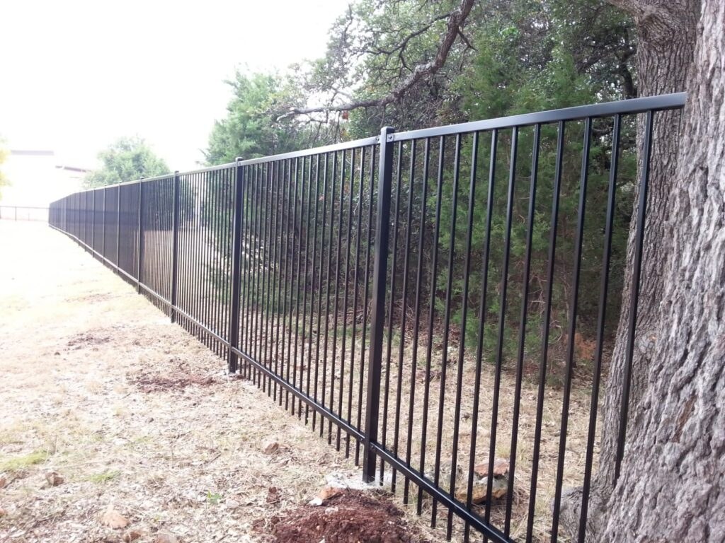 Long black iron fence along a property line