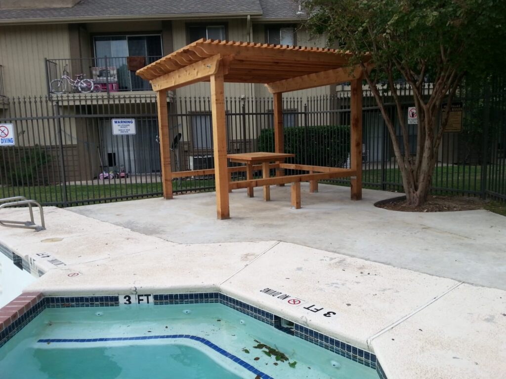 Wood pergola over a pool patio