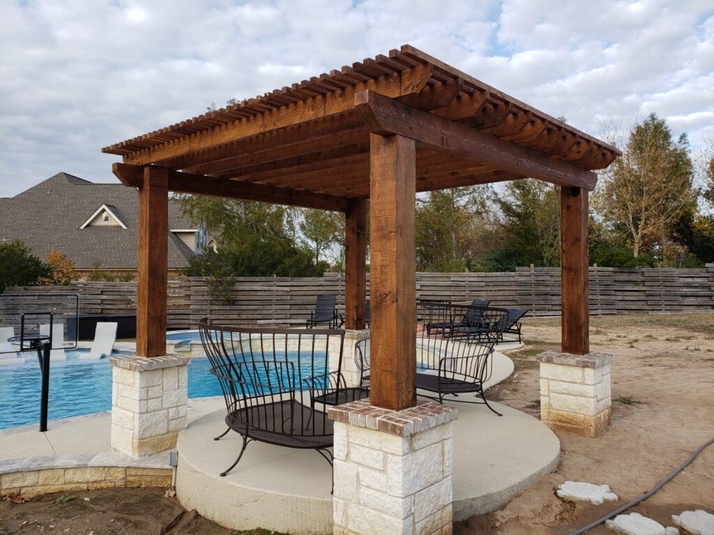 Wood pergola gazebo beside a swimming pool