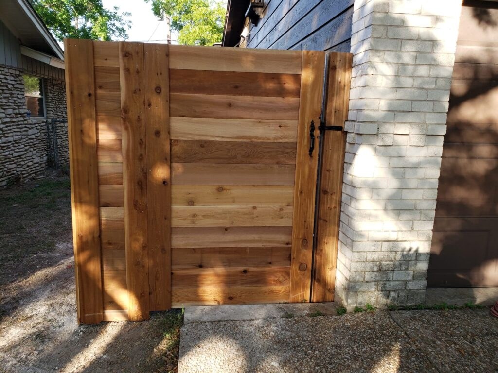 Double cedar gate in a backyard fence